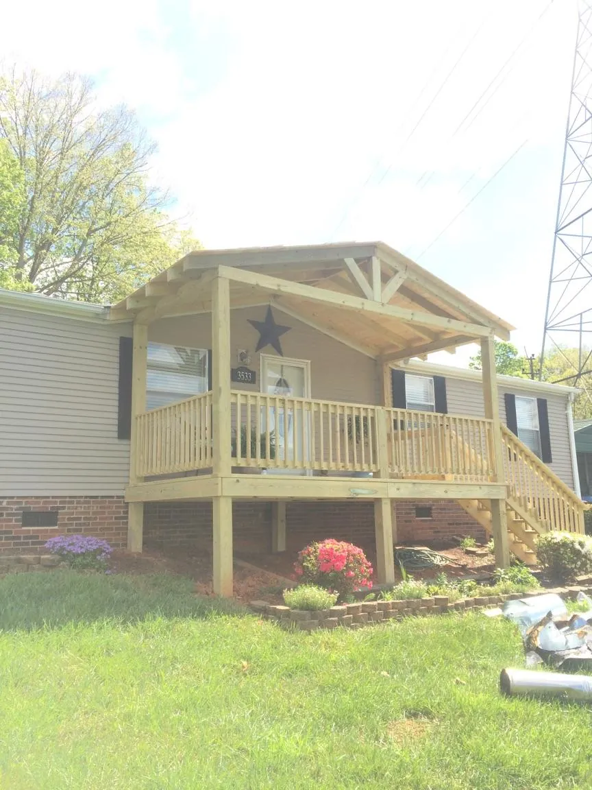 New gabled porch roof and deck railing added to a ranch home in Montclair